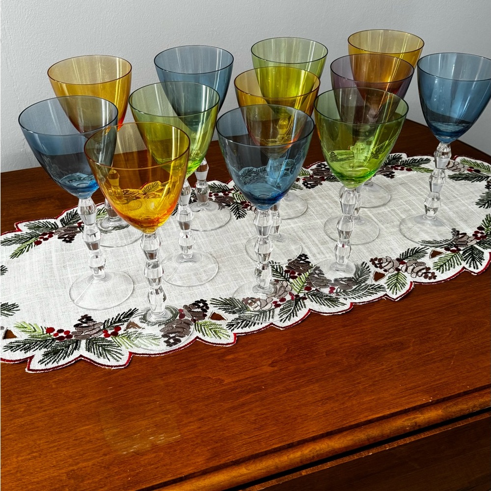 12 multi colored wine/ water glasses that have been stored in a china closet.